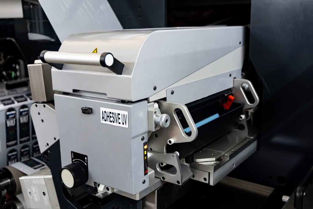 adhesive uv station of the abg digital embellishment printing machine